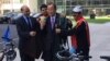 Afghan Ambassador to the UN Mahmoud Saikal, left, watches as Firoz Khan, second from left, and Nader Shah Nangarhari, right, give U.N. Secretary-General Ban Ki-moon a traditional Afghan chapan. (M. Besheer/VOA)