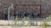 FILE - In this Oct. 8, 2014, photo, police officers take positions by nooses prepared to execute men at a jail in Kabul, Afghanistan. Afghanistan has hanged six men convicted of terrorism, signaling a tougher approach toward the Taliban.