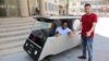 Khaled Bardawil and Jamal al-Meqati pose with their solar-powered car. (Courtesy: Gaza Al-Azhar University)