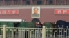 Police officers set up barriers in front of the giant portrait of the late Chinese Chairman Mao Zedong as they clean up after a car accident at Tiananmen Square in Beijing, Oct. 28, 2013. 