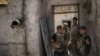 Iraqi special forces soldiers stand in a house retaken during fighting against Islamic State militants in the Old City of Mosul, Iraq, June 27, 2017. The Old City is the last IS stronghold in Mosul.