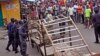 FILE - Liberia security forces blockade an area around the West Point Ebola center as the government clamps down on the movement of people to prevent the spread of the Ebola virus in Monrovia, Liberia. 