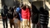 FILE - Pakistani suspects allegedly affiliated with the Islamic State group, wait to appear in the anti-terrorist court, in Gujranwala, Pakistan, on Dec. 29, 2015. 