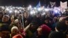 FILE - People take part in a street protest to show solidarity with judges facing increased political pressure from the country's right-wing government, in Warsaw, Poland, Dec. 1, 2019.