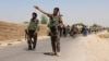 FILE - An Afghan National Army (ANA) soldier gestures as they arrive in Nad Ali district of Helmand province, southern Afghanistan, Aug. 10, 2016. An American soldier died during the operation near the provincial capital of Lashkar Gah, Aug. 23, 2016.