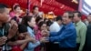 FILE PHOTO - Prime Minister Hun Sen greets garment workers during a visit to a factory outside of Phnom Penh, Cambodia, Wednesday, Aug. 30, 2017. 