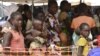 FILE - Internally-displaced people wait in line for medical attention at the 'Medecins sans Frontieres' (MSF) hospital based in the IDP camp near the international airport in Bangui, Dec. 23, 2013. 