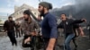 Syrians carry away the body of a man retrieved from the rubble of a building following a regime airstrike on a vegetable market in Syria's last major opposition bastion of Idlib, Jan. 15, 2020.