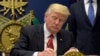FILE - President Donald Trump signs an executive order on extreme vetting during an event at the Pentagon in Washington, Jan. 27, 2017.