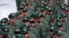 FILE - Iranian Revolutionary Guard members arrive for a ceremony celebrating the 40th anniversary of the Islamic Revolution, at the Azadi, or Freedom, Square, in Tehran, Iran, Feb. 11, 2019.