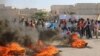 FILE - People gather near burning tires during a demonstration against forces loyal to Syria's president Bashar al-Assad and calling for aid to reach Aleppo near Castello road in Aleppo, Syria, Sept. 14, 2016.