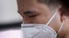 A man wearing a face mask cries in Wuhan, Hubei province, as China holds a national mourning for those who died of COVID-19 on the Qingming tomb-sweeping festival April 4, 2020. 