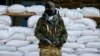 An armed man, who is wearing black and orange ribbons of St. George - a symbol widely associated with pro-Russian protests in Ukraine, stands guard in front of barricades outside the mayor's office in Slovyansk April 18, 2014. 