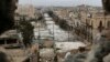 FILE - A general view shows damaged buildings along a deserted street and an area controlled by forces loyal to Syria's President Bashar Al-Assad, as seen from a rebel-controlled area at the Bab al-Nasr frontline in Aleppo, Feb. 10, 2015. 