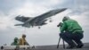 Mass Communication Specialist 2nd Class Sean Castellano, from Colorado Springs, Colo., records video footage on the flight deck of the Nimitz-class aircraft carrier USS Carl Vinson in the western Pacific region, May 23, 2017.