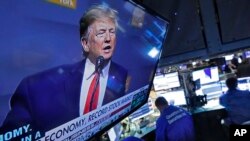 A television screen on the floor of the New York Stock Exchange shows President Donald Trump's speech to the Economic Club of New York, Nov. 12, 2019. 