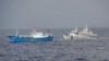 Japan Coast Guard patrol boats approach a Chinese fishing boat, left, off the northeastern coast of Miyako island, about 200 kilometers (124 miles) southwest of the disputed islands, called Senkaku in Japan and Diaoyu in China, February 2, 2013.