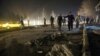 Afghan security forces inspect the site of a suicide attack near the Russian embassy in Kabul, Afghanistan, Jan. 20, 2016. 