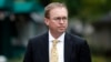 FILE - Mick Mulvaney departs after a television interview at the White House, Sept. 13, 2017, in Washington.