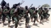 FILE - Hundreds of al-Shabab fighters perform military exercises in the Lafofe area 18 kilometers south of Mogadishu, Somalia, Feb. 17, 2017. 