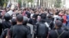 FILE - Cairo University students who support the Muslim Brotherhood and ousted Egyptian President Mohamed Morsi shout slogans against the military and Interior Ministry in front of riot police at the main gate of the university, Cairo, Nov. 24, 2013.