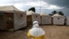 FILE - A health worker wearing Ebola protection gear prepares to enter the Biosecure Emergency Care Unit at an Ebola treatment center in Beni, Democratic Republic of Congo, March 30, 2019.