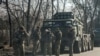 Ukrainian army soldiers stand next to multiple launch missile systems, after Russian President Vladimir Putin authorised a military operation, in eastern Ukraine, in Kharkiv region, Ukraine February 24, 2022.