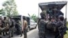 Members of the Philippine National Police Special Action Forces load bodies of police commandos into vehicles in Maguindanao, Philippines, Jan. 26, 2015.