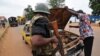 A gendarme checks a driver's car at a checkpoint in the PK4 district of Bangui, Feb. 27, 2014. 