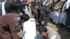 Afghan mourners handle the coffin for a victim killed in the April 19 Taliban truck bomb attack, in Kabul, April 20, 2016.