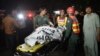 Pakistani rescuers use a stretcher to shift a body from a bomb blast site in Lahore on March 27, 2016. 