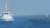 An Iranian vessel steers close to the U.S. Navy coastal patrol craft USS Thunderbolt (R) in the Persian Gulf in a still image from video provided by the U.S. Navy, July 25, 2017.