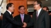 Cambodian Prime Minister Hun Sen, left, shakes hands with opposition party leader Sam Rainsy, right, after a meeting, as Sar Kheng, center, deputy prime minister, looks on at the National Assembly in Phnom Penh, Cambodia, Monday, Sept. 16, 2013. Hun Sen and Sam Rainsy met for the second time on Monday in a bid to resolve a political stalemate, a day after violent clashes on the streets of Phnom Penh. (AP Photo/Heng Sinith)