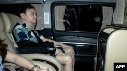 Thailand's former prime minister Thaksin Shinawatra arrives at his family compound after he was released from a police hospital in Bangkok on Feb. 18, 2024.