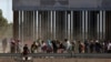 FILE - Migrants queue to request asylum after crossing illegally into El Paso, in this picture taken from Ciudad Juarez, Mexico, April 21, 2019.