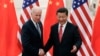 Chinese President Xi Jinping, right, shakes hands with U.S Vice President Joe Biden, left, as they pose for photos at the Great Hall of the People in Beijing, Dec. 4, 2013. 