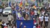 FILE - Protesters, bearing the flags of opposition parties, demonstrate against President Joseph Kabila remaining in power if the presidential election is not held before the end 2016, in Kinshasa, May 26, 2016.