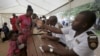 Refugees fleeing anti-immigrant violence are processed by immigration officers at a transit camp in Beit Bridge, ZImbabwe, April 24, 2015.
