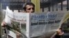 A man reads a Kurdish newspaper in southeastern city of Diyarbakir, Turkey, March 22, 2009.