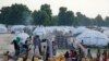 FILE - People displaced by Islamist extremists queue for water at the Muna camp, in Maiduguri, Nigeria, Aug. 30, 2016.