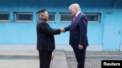 U.S. President Donald Trump shakes hands with North Korean leader Kim Jong Un as they meet at the demilitarized zone separating the two Koreas, in Panmunjom, South Korea, June 30, 2019. KCNA via REUTERS ATTENTION EDITORS - THIS IMAGE WAS PROVIDED…