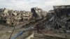 Damaged buildings and debris are pictured in the besieged area of Homs, Syria, Dec.24, 2013. 