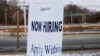 FILE - A sign advertises open jobs at an Embassy Suites hotel in Waltham, Massachusetts, Dec. 13, 2017.
