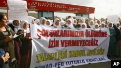 Kurdish women demonstrate near a prison in Sincan, on the outskirts of Ankara, Turkey, Friday, Nov. 2, 2012.