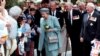 FILE - Queen Elizabeth (C) receives flowers and letters from the public as she walks with the Duke of Edinburgh (center rear) following a ceremony honoring World War II veterans in Wellington, New Zealand, Nov. 5, 1995.