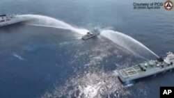 In this image made from video provided by the Philippine Coast Guard, a Philippine Coast Guard vessel is blasted by Chinese coast guard water cannons as it approached waters near Scarborough Shoal, locally known as Bajo De Masinloc, in the South China Sea on April 30, 2024.