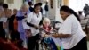 Elderly and disabled South African voters, assisted by nurses, cast their ballots during early voting for special groups at the Nazareth House old-age home in Johannesburg, South Africa, May 5, 2014.