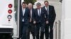 Republican senators walk in the rain back to their bus at the North Portico of the White House in Washington, Oct. 11, 2013.