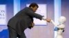 Astrophysicist Neil deGrasse Tyson interacts with Pepper, a social humanoid robot, during the Clinton Global Initiative's annual meeting in New York, Sept. 28, 2015. 