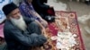 FILE - Pakistan's humanitarian leader Abdul Sattar Edhi collects donations at a roadside spot in Peshawar, Pakistan, Aug. 2, 2010.